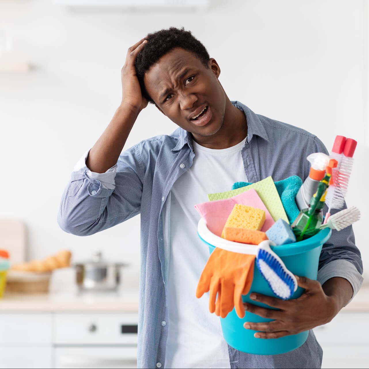 confused-black-guy-holding-busket-with-cleaning-to-2021-09-03-00-42-13-utc-e1661826375844.jpg